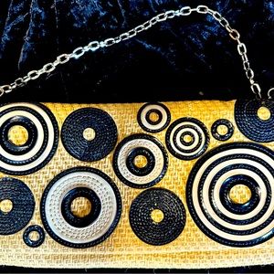 Cole Haan woman’s purse with shoulder chain. The inside has a zip closure.